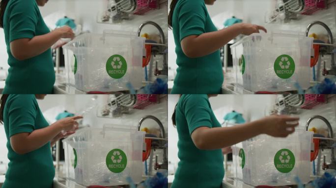 手取塑料瓶，放入垃圾袋准备回收