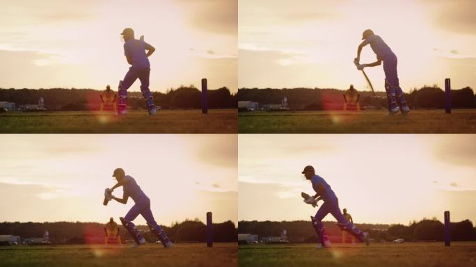 职业印度板球运动员在蓝色制服和保护装备击球和捍卫三柱门。一个阳光明媚的下午，运动员在绿色的场地上练习