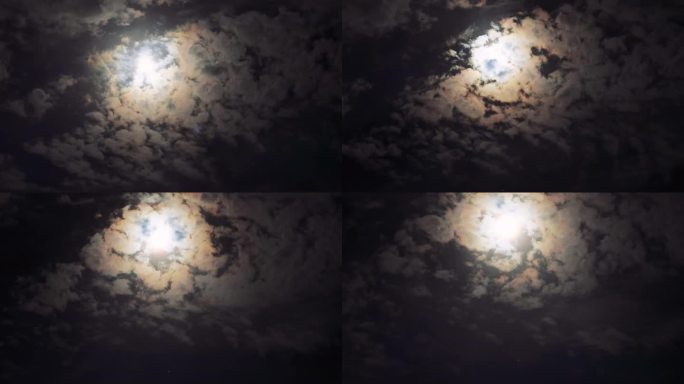 这张延时拍摄的照片捕捉到了海面上升起的满月，被漂浮的云框住，背景是一个沿海城市，创造了一个迷人的天体