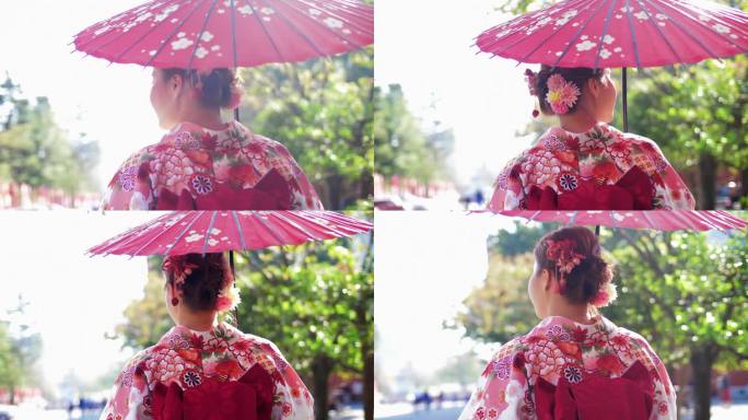 穿着日本传统和服的亚洲妇女走在老城区