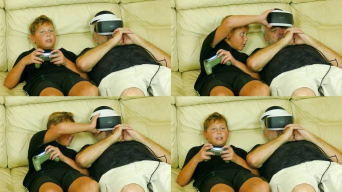 男孩在他熟睡的父亲旁边玩电子游戏