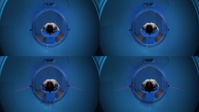 在医学实验室，躺在CT或MRI扫描床上的匿名女性患者的镜头正在接受红色激光的扫描程序。床向镜头移动。