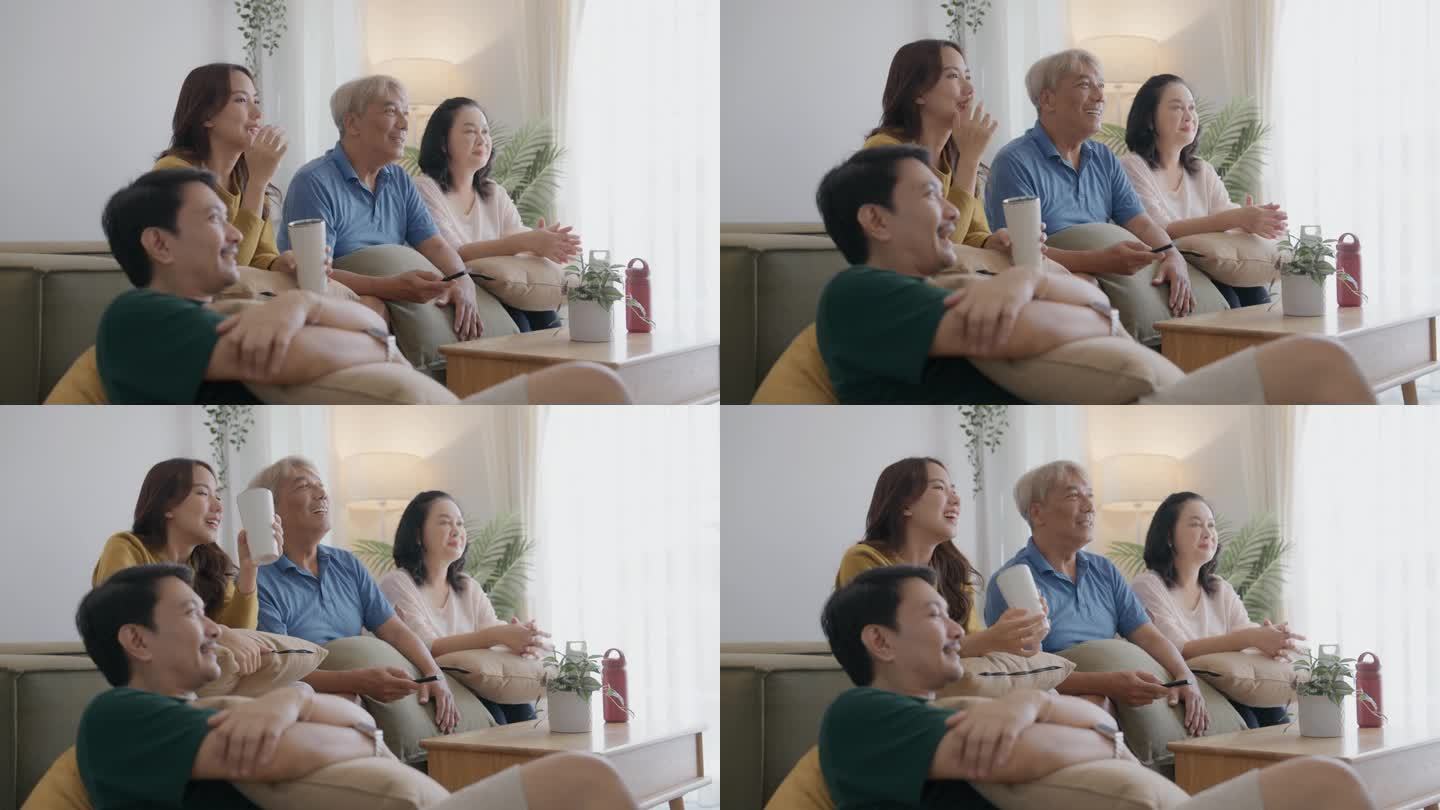 亚洲家庭在家里度过安静的夜晚。妈妈、女儿和爷爷坐在沙发上看电视。