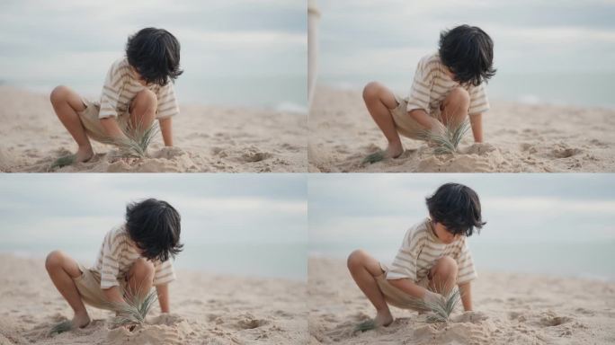 快乐的亚洲男孩在度假时在沙滩上堆沙堡