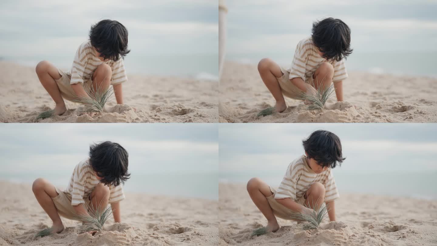 快乐的亚洲男孩在度假时在沙滩上堆沙堡