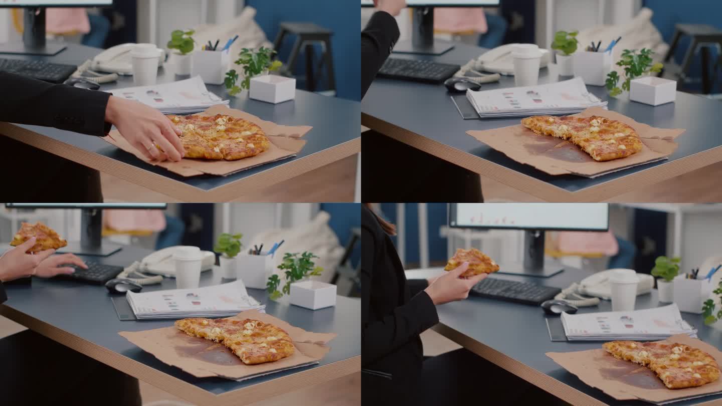 执行经理在电脑前吃披萨的特写
