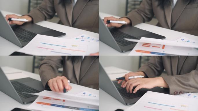 在现代办公室里用笔记本电脑做营销计划的女商人