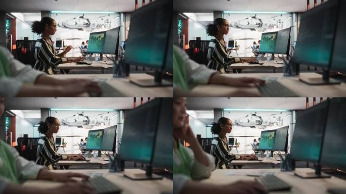 专注于女性黑人游戏开发者使用桌面电脑与3D建模软件，以创造身临其境的游戏世界在办公室。前景:亚洲女性