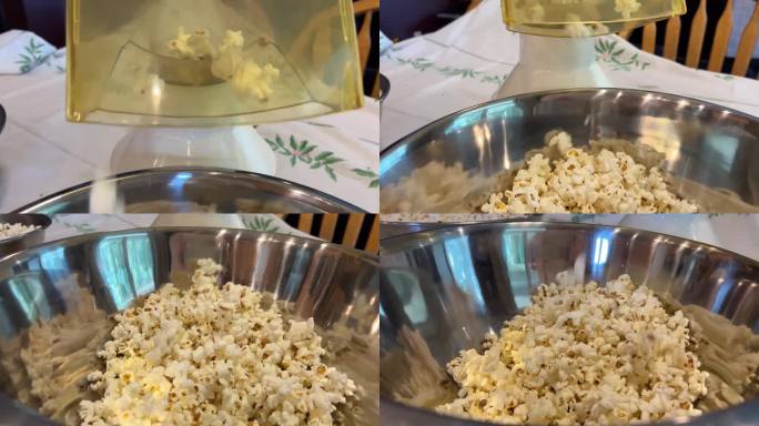 在工业爆米花机里拍摄的新鲜爆米花的静态照片，变成新鲜爆米花的玉米从爆米花机里掉出来