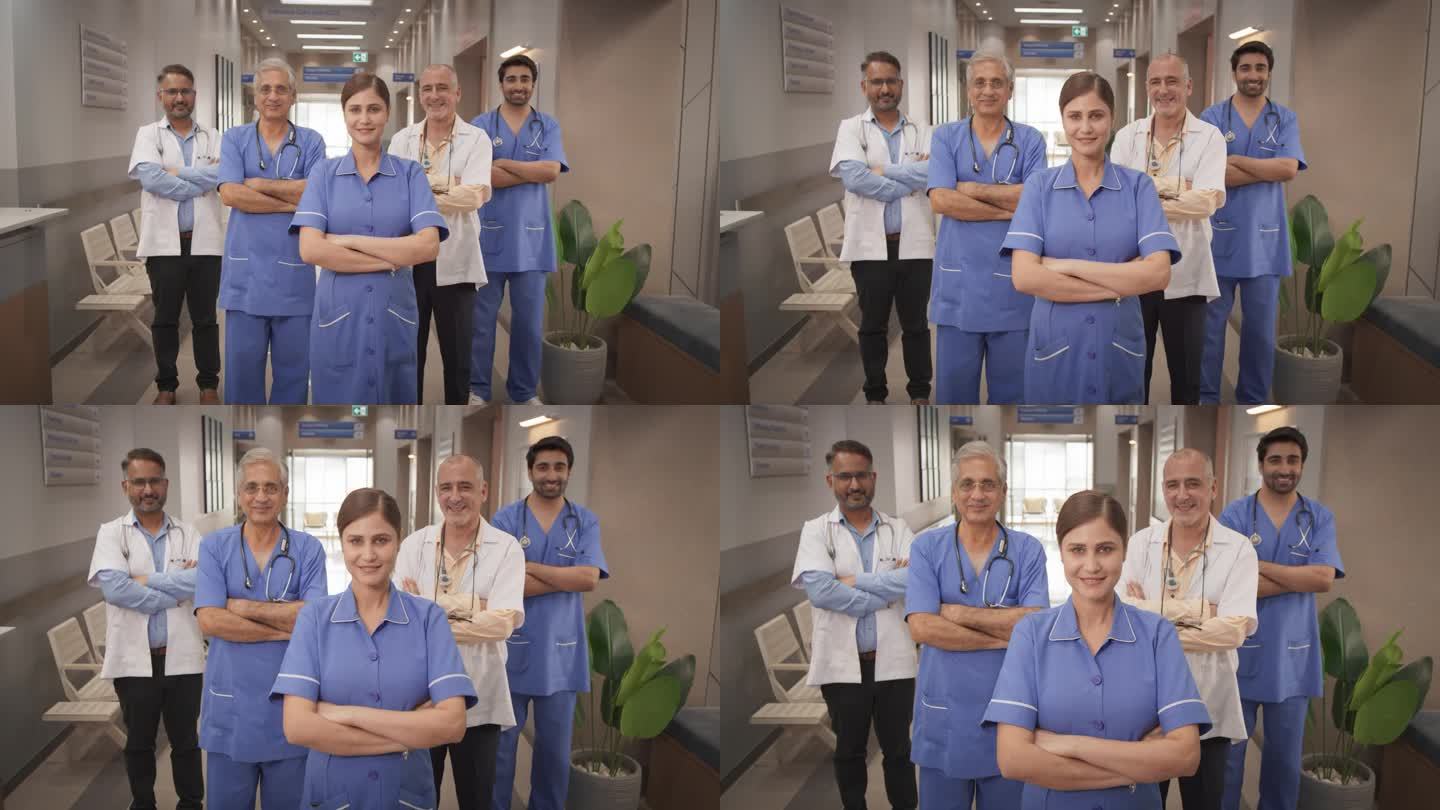 印度医疗保健:一名成功的不同医疗保健专业人员的团队肖像，他们站在现代医院办公室里，摆姿势，看着相机，