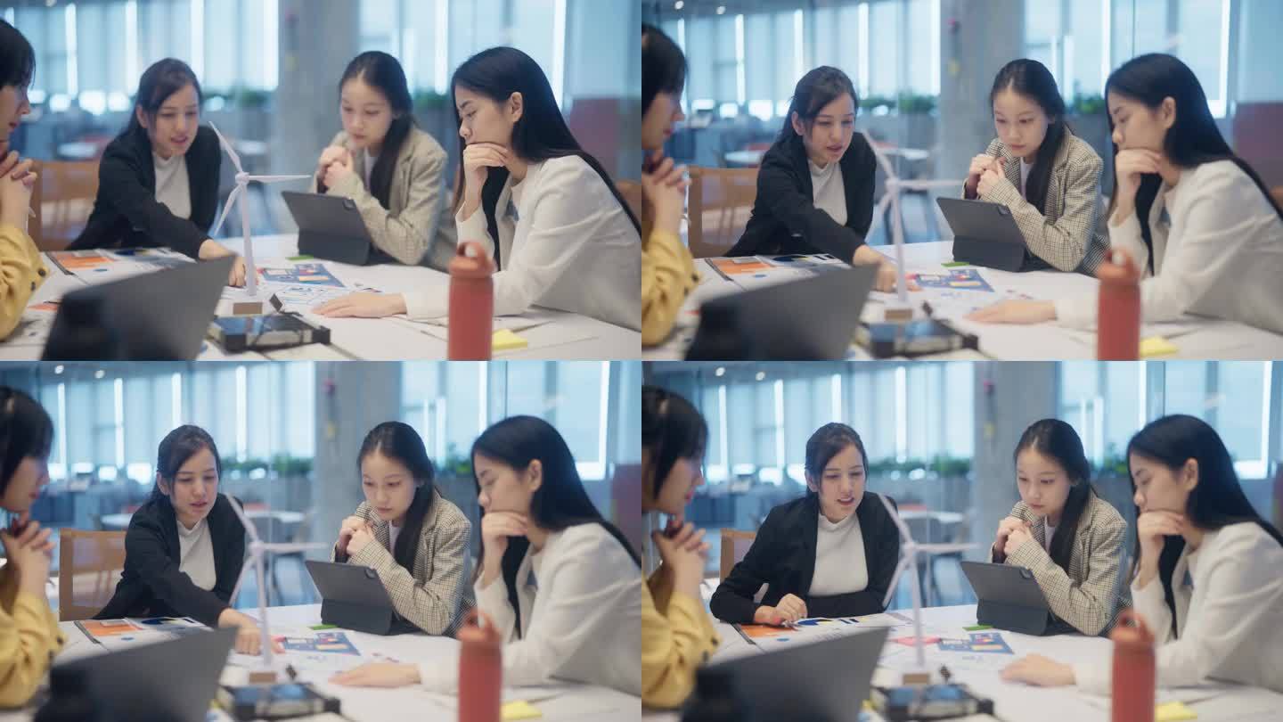 在现代办公室里，亚洲同事正在放松头脑风暴，讨论可再生能源项目