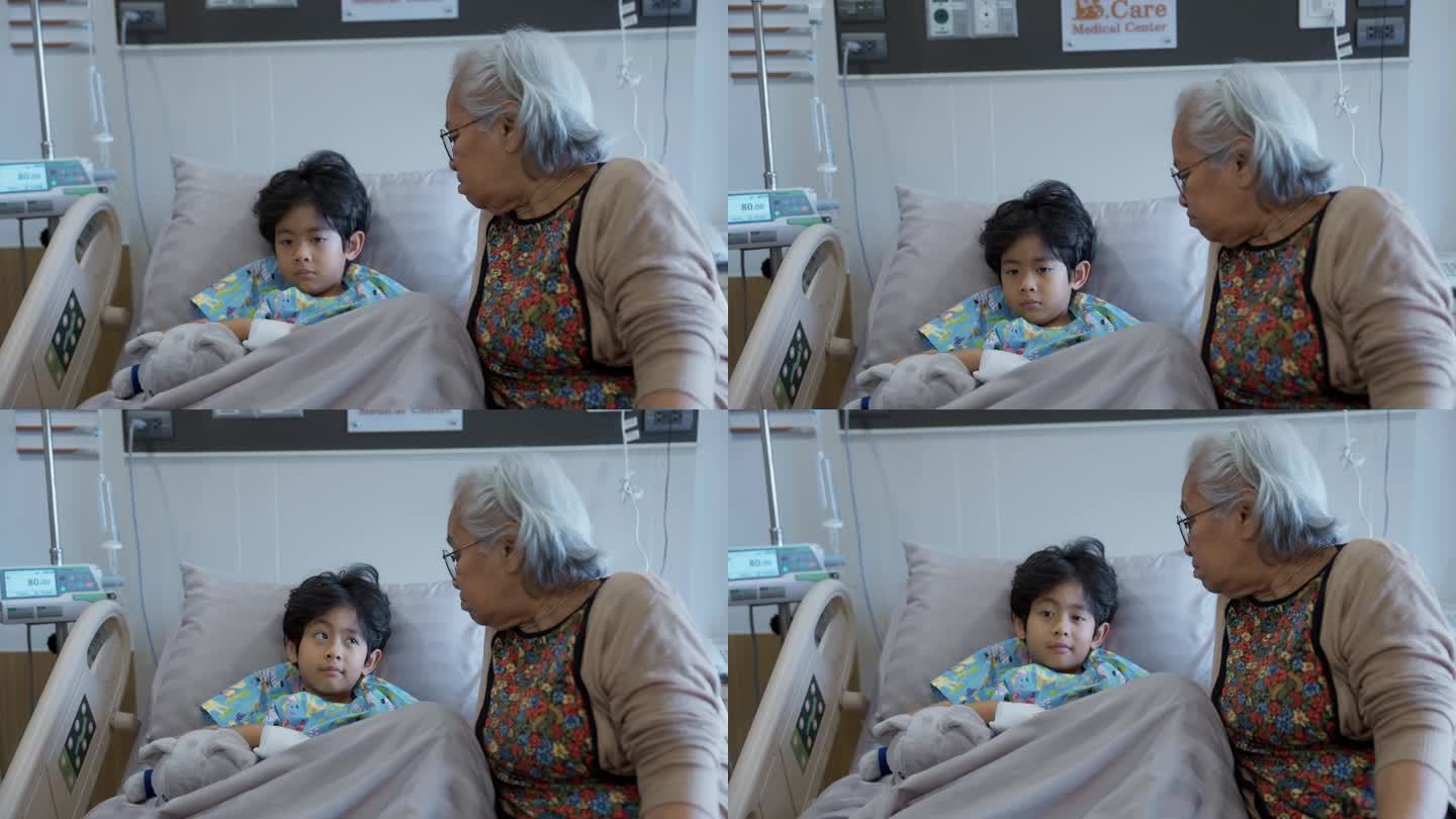 一位亚洲老太太正在和她得了流感住院的孙子说话。