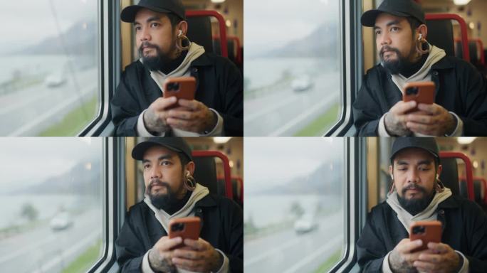 亚洲游客在乘坐火车时用手机阅读和聊天。