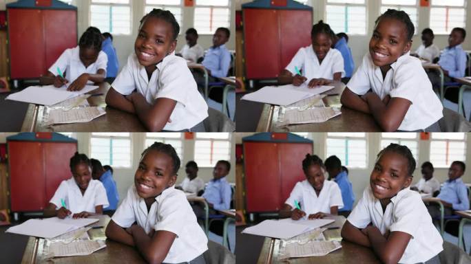 特写镜头。非洲一名黑人女学生坐在非洲教室的课桌前对着镜头微笑