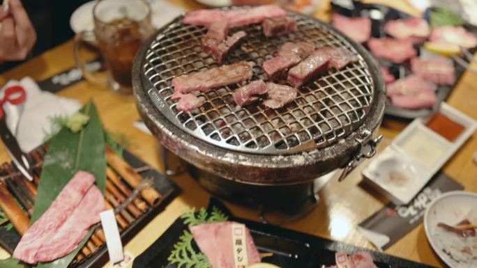 在日本大阪，亚洲女游客正在吃烧牛肉A5和最昂贵的肉