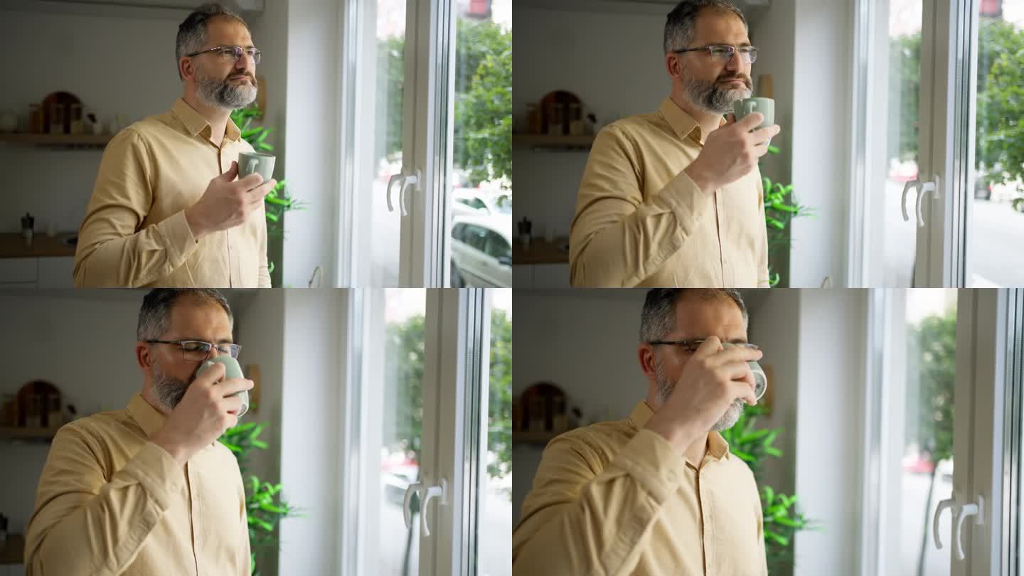 白人中年男子的b卷，看着窗外，喝着咖啡