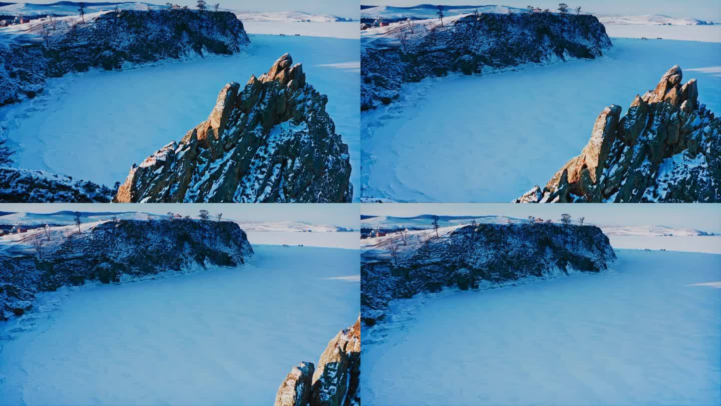 贝加尔湖在冬天被冰雪覆盖。飞越奥尔洪岛上的沙曼卡岩石。俄罗斯西伯利亚贝加尔湖，黎明时分美丽的冬日风景