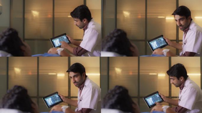 医院病房:年轻的印度男医生与躺在床上的病人交谈，使用平板电脑，展示并解释背部CT MRI扫描结果。医