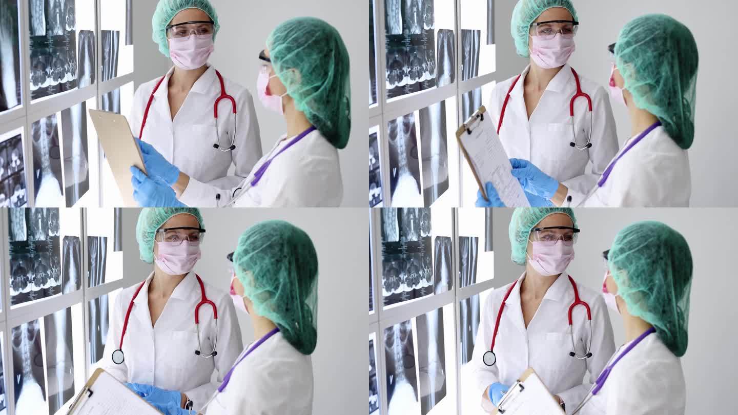 戴着防护口罩和眼镜的女医生正在看医疗文件和x射线4k电影