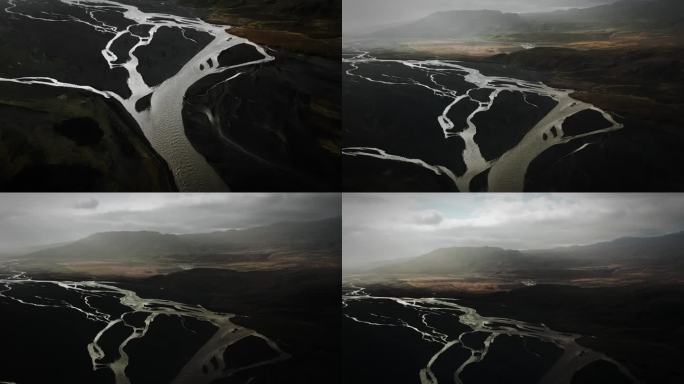 空中倾斜托尔山谷，飞越冰川河流流经黑色火山山脉，thorsmörk冰岛戏剧性的喜怒无常的景观