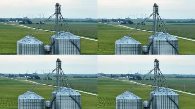 美国中西部的谷物升降机。用长焦变焦镜头航拍。背景是风力涡轮机和玉米田。
