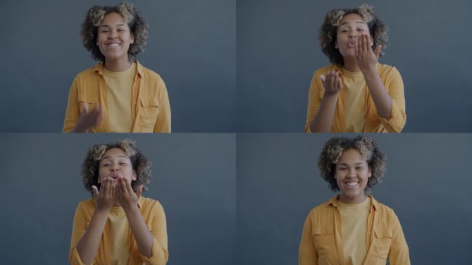 深情的非裔美国妇女对着镜头微笑飞吻的慢动作肖像