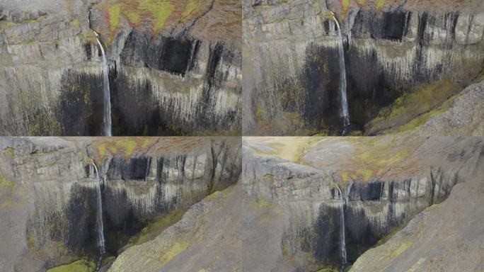 空中倒转拍摄白天冰岛火山景观中的瀑布