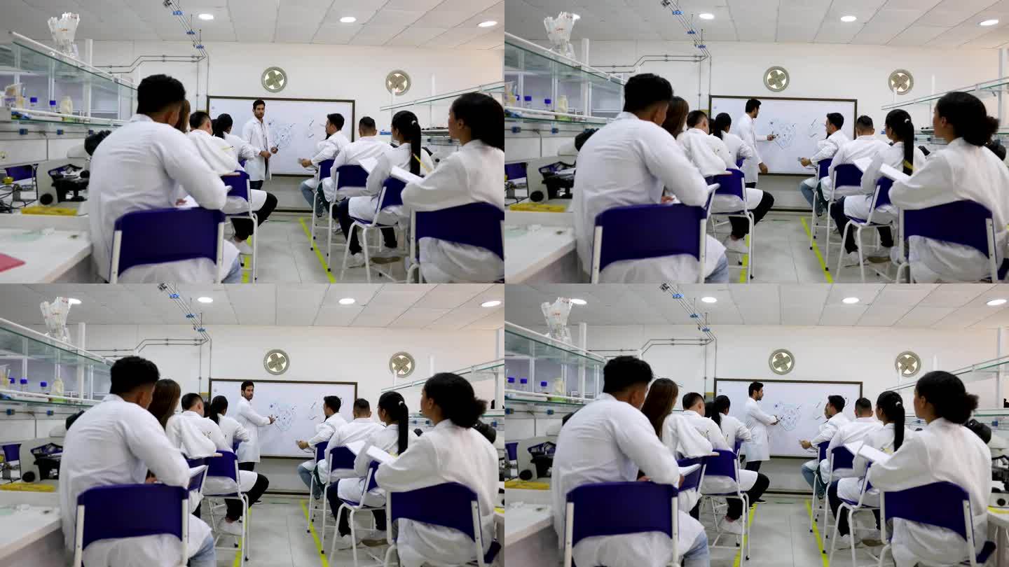生物系学生注意听男老师讲解一些概念，然后用显微镜分析样品