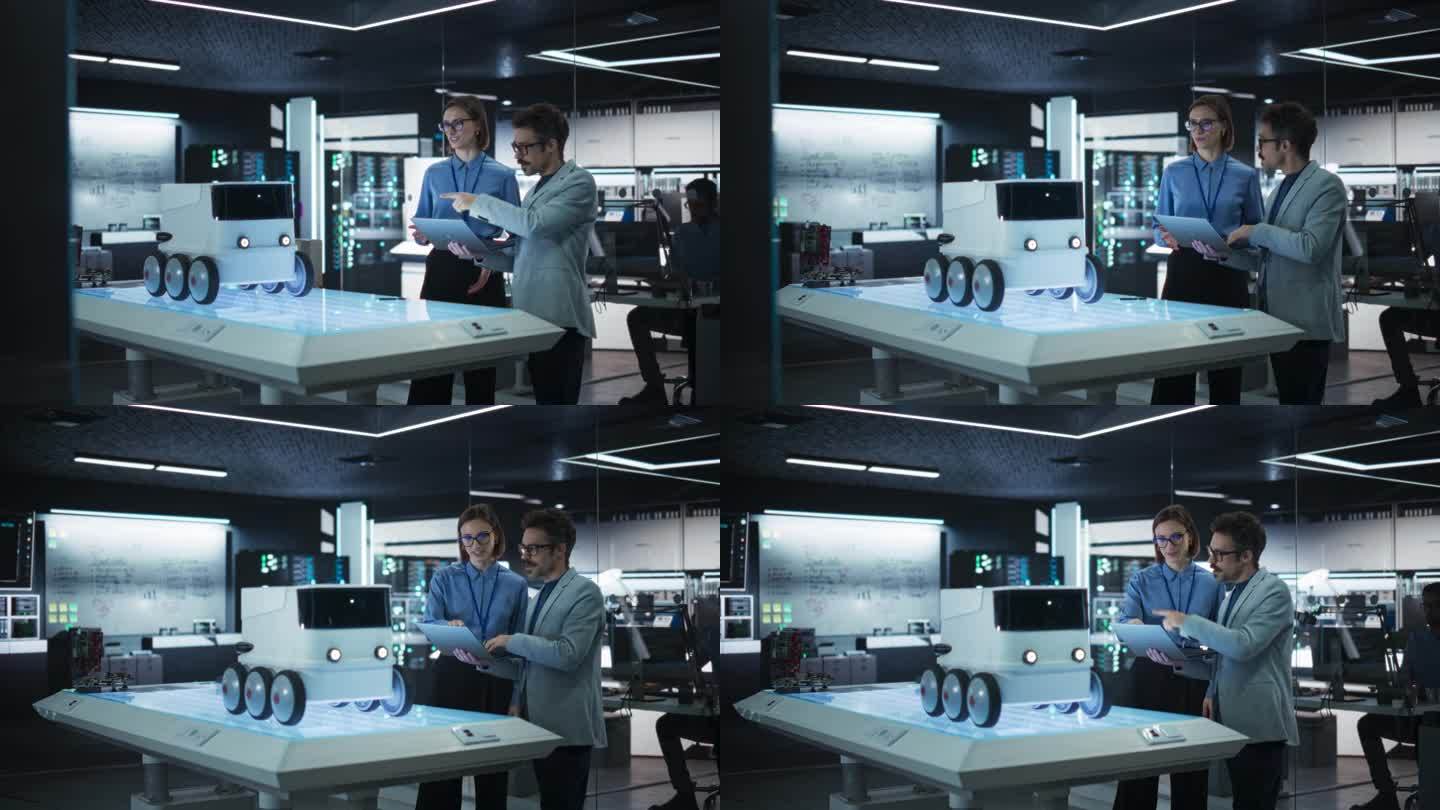 两位在研究机构工作的同事的肖像，使用笔记本电脑开发用于自动送货的未来机器人。制造专家向团队经理做演示