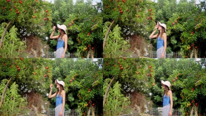 戴太阳帽的女孩在花园里闻熟苹果