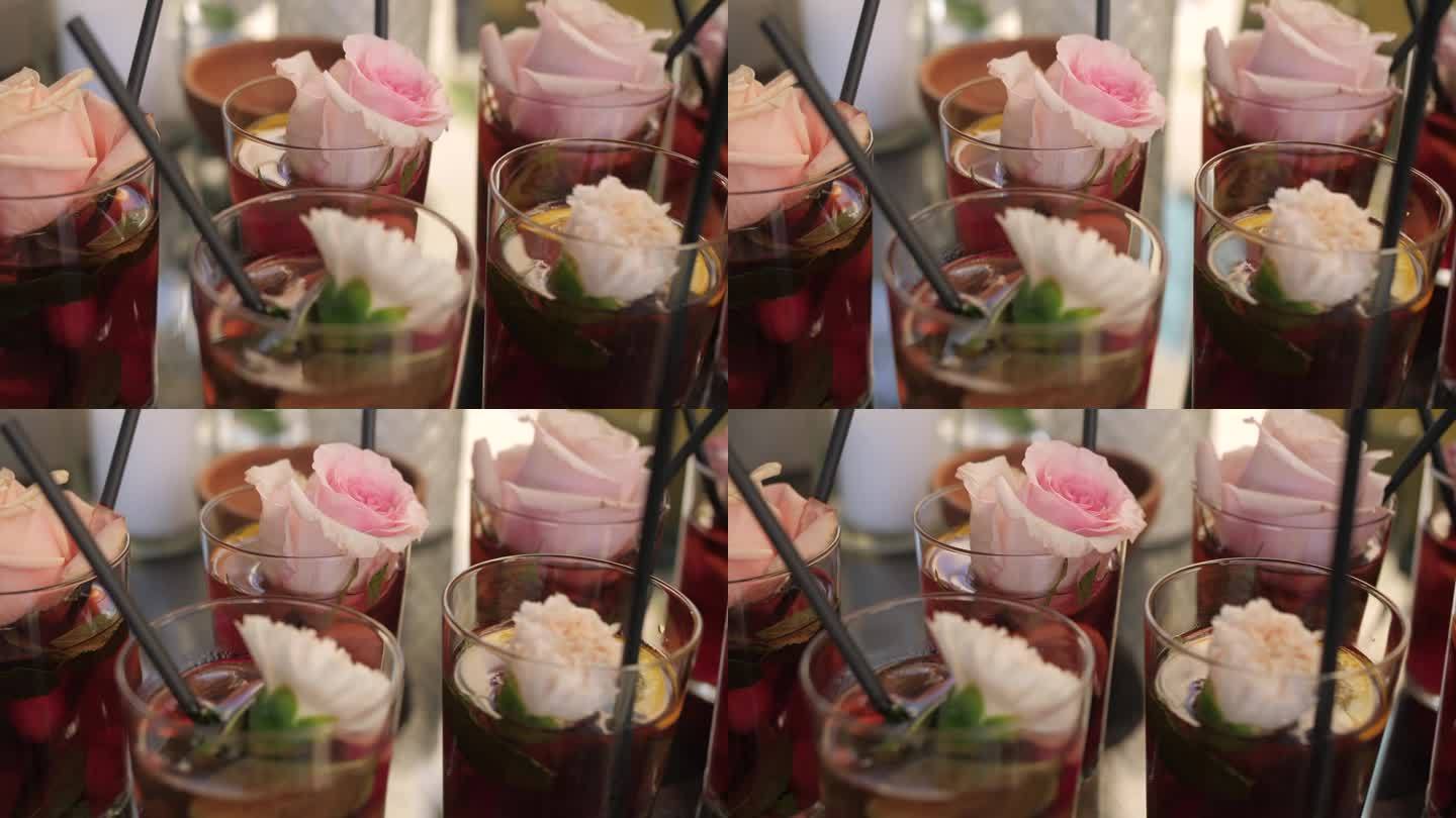 鸡尾酒与玫瑰装饰的玻璃，在聚会上花式饮料的特写镜头