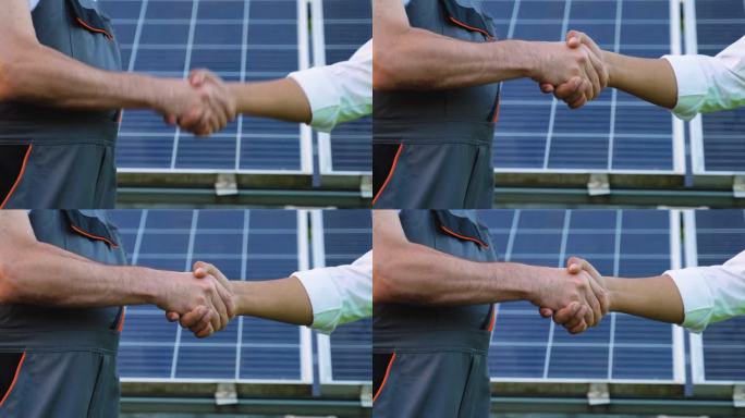 两位工程师，印度经理和高级下属在讨论完光伏太阳能板的背景后握手，拉近距离