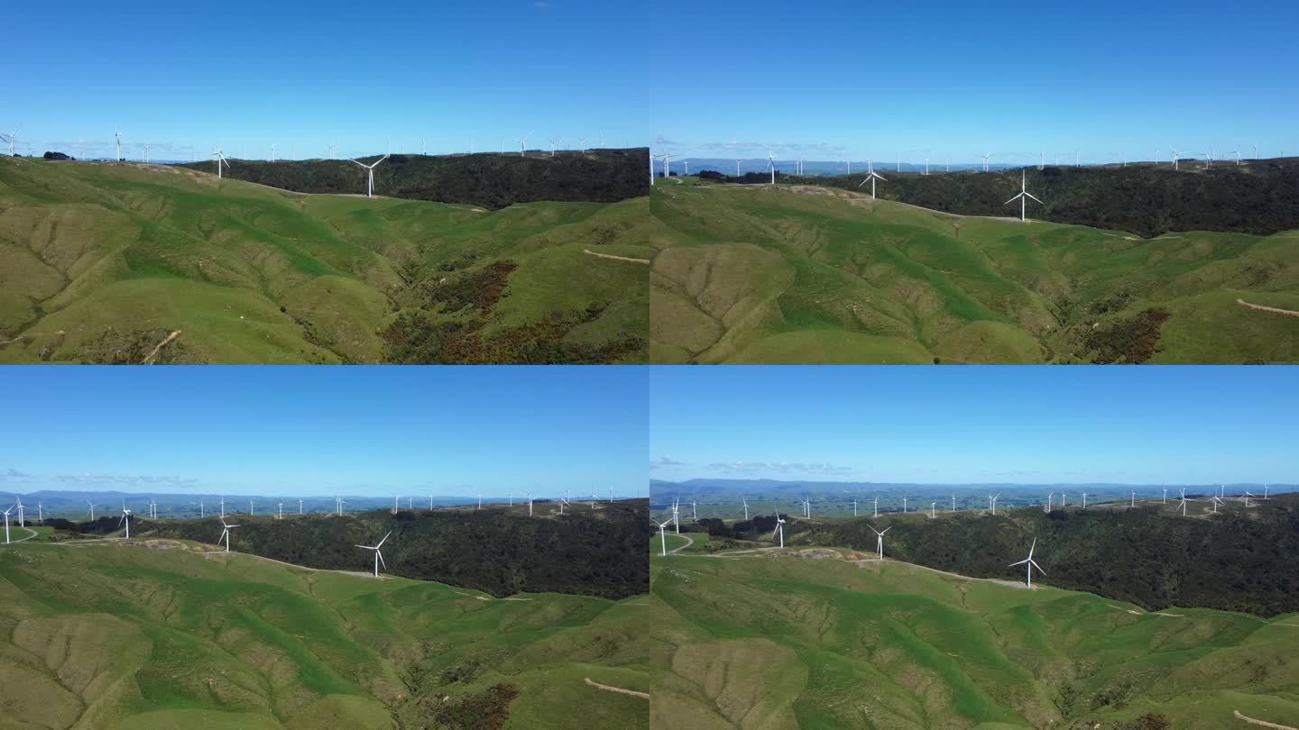 慢慢上升，显露出高山上的风力发电场。美丽的景色一直延伸到地平线。马纳瓦图，新西兰。