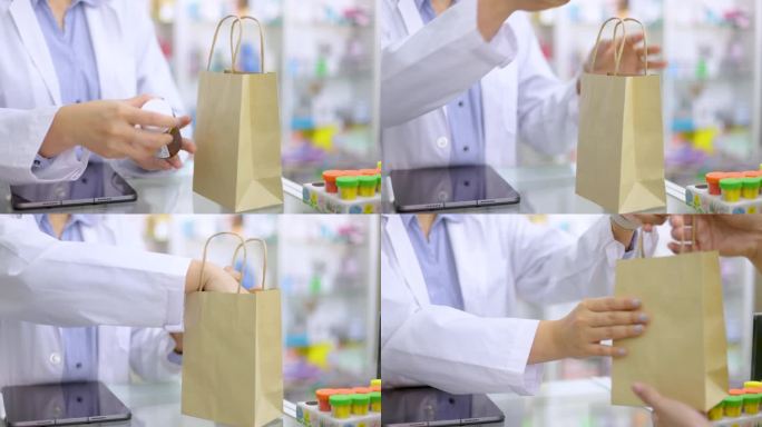 药剂师将处方药放入白色袋子并递给顾客的手