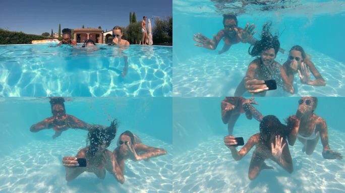 女友用智能手机在水下自拍的慢镜头。跟踪拍摄三个女人在炎热的夏天享受茶水，在水疗中心或酒店游泳