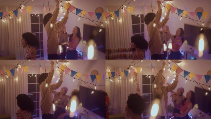 一群亚洲朋友正在用旗帜和灯光装饰房间，准备晚上聚会。