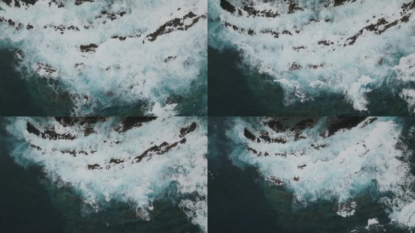 危险的海浪冲击着岩石——高空拍摄的无人机镜头。动力水。美丽的海边适合冲浪。