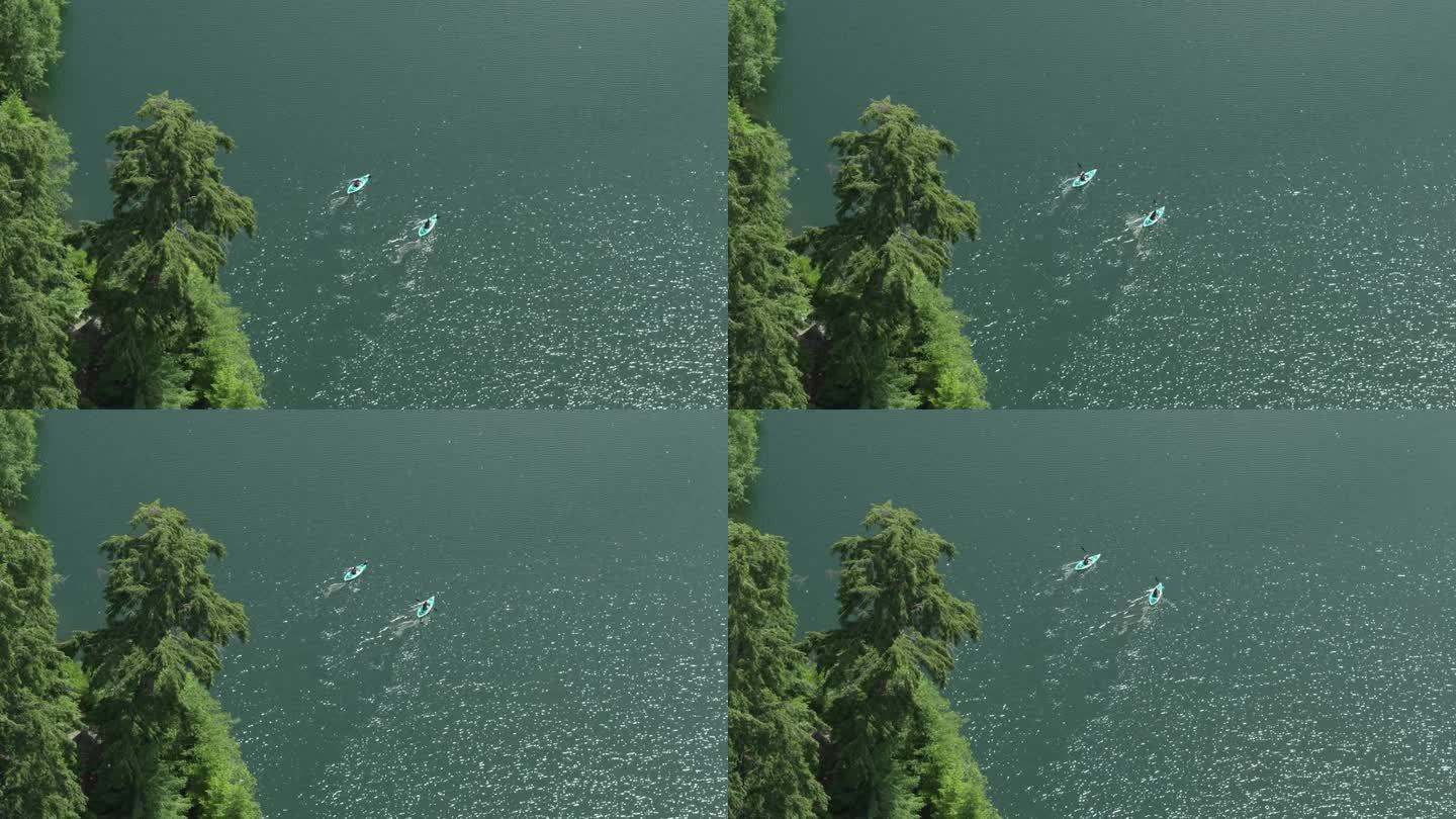 夏天，在加拿大惠斯勒的原始绿松石平静湖上的高角度航拍皮划艇者