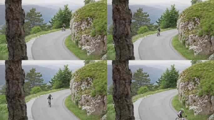 一个骑山地自行车的男人沿着一条漂亮的山路骑着