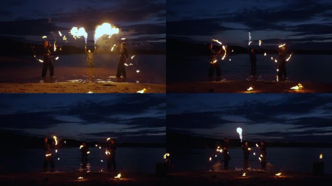 夜河岸边神秘的火焰表演，人们在黑暗中旋转燃烧的火炬