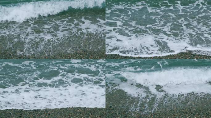 海浪拍打着鹅卵石的海滩，海浪拍打着海滩。海浪冲刷卵石滩。不动。