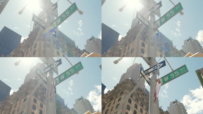 纽约市灯柱上悬挂的多个彩色街道标志的低角度镜头。单行道，西55街，酒店装货区。旅游理念，夏日旅游