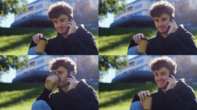 在城市的公园里，一个快乐的年轻人一边喝咖啡一边用智能手机聊天。的生活方式。秋季散步的概念。实时概念。