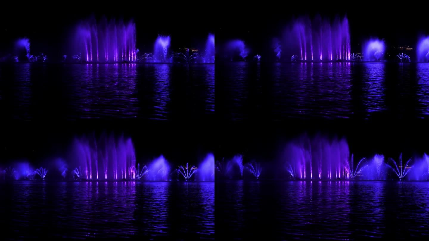 一个美丽的歌唱喷泉，在一个小湖上有五颜六色的水流。