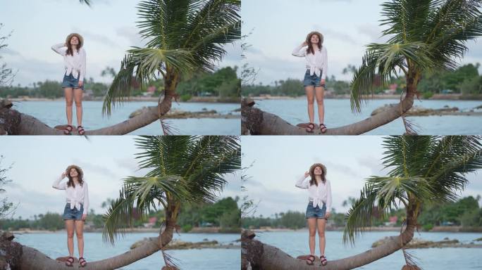 一个女人站在海滩上的棕榈树旁