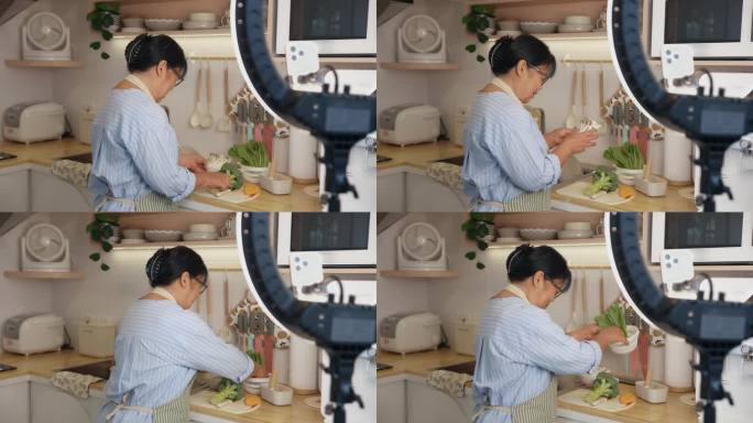 亚洲老年妇女在社交媒体上直播，教授烹饪。