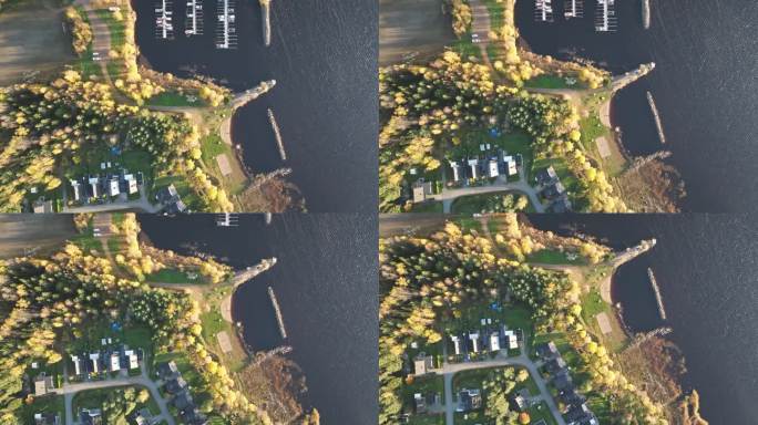 瑞典湖滨码头附近的秋叶住宅村。空中俯视图