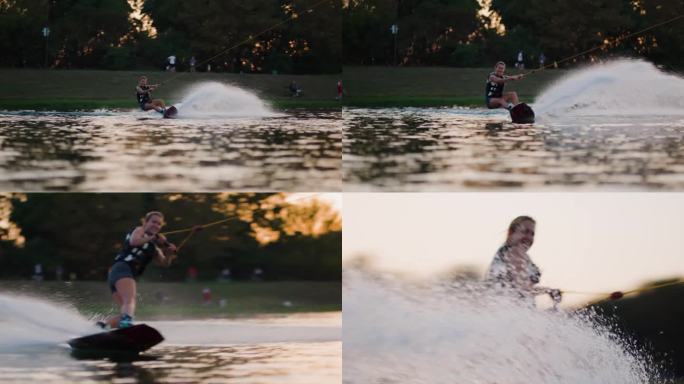 日落时分的女子滑水板运动员。女孩骑在滑水索上。握住牵引绳。夏天在湖里活动。