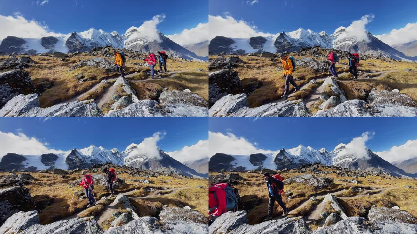 三名探险队员背着背包，沿着卡雷附近的马卡鲁巴伦公园徒步旅行路线行进。攀登梅拉峰适应步行。背包客用登山