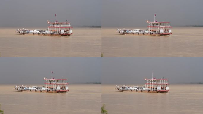 湄公河上载着汽车和乘客的渡轮，背景是壮观的天空